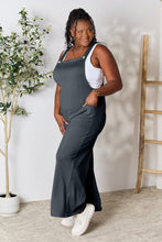 Side angle showing wide-leg cut of Cloudy Blue Cyrella Muse Overalls.