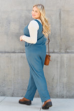 Back view of model in Sky Blue Caeloura Jumpsuit, captured against a urban backdrop.