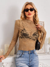 Model wearing a Mock Neck Long Sleeve Lace Sheer Top in camel, showing intricate floral lace details and flattering fit with denim jeans.