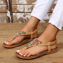Model wearing camel pair of PU Leather Beaded Flat Sandals