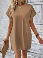 Woman wearing Camel Rahluna Mini Tee Dress showcasing cuffed sleeves and side pocket detail.
