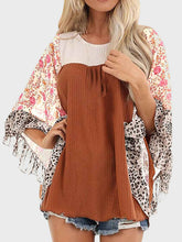 Woman wearing BlossomEase Blouse in caramel with floral sleeves and relaxed fit.
