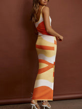 Back view of Caramel Luxnometry Maxi Sweater Dress highlighting angular patterns in a grand mansion room.