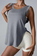 Model styling charcoal slit round neck active tank with leggings and sneakers.
