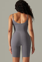 Charcoal active romper back view showing thick spaghetti straps and contoured fit.