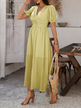 Model wearing chartreuse Velunira dress at an upscale garden party.