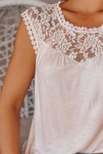 Close-up detail of lace patchwork neckline and semi-sheer fabric in beige.