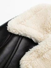 Close-up of mock shearling collar and faux leather stitch on the black/white Nuvira Frostloom cropped jacket.