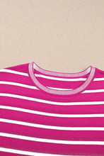 Close-up of hot pink soft striped knit fabric and round neckline detail on short sleeve top, highlighting texture and quality.
