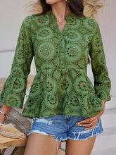 Close-up of Moss Luméa™ Blouse's eyelet fabric and half-button closure on model paired with a straw hat and accessories for a casual look.