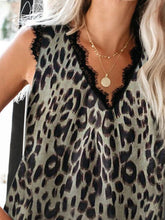 Close-up of neckline and delicate lace detail on dark gray animal print tank