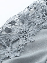 Close-up of the lace floral detailing on the shoulder cutouts.
