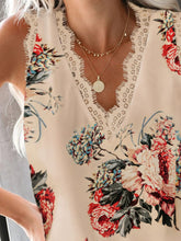 Close-up of neckline and delicate lace detail on pastel yellow floral print tank