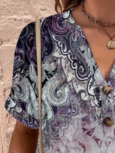 Close-up of pink purple fabric, buttons, and notched neckline detail.