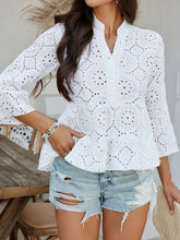Close-up of White Luméa™ Blouse's eyelet fabric and half-button closure on model paired with a straw hat and accessories for a casual look.