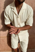 Man clapping while wearing creamy white Cordavé CoastFlex Shorts Set