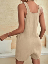 Cream romper back view with soft textured fabric and loose silhouette.