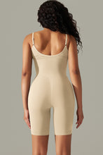 Cream active romper back view showing thick spaghetti straps and contoured fit.
