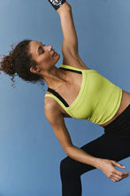 Woman stretching in chartreuse Scoop Neck Active Tank.