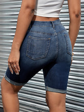Back view of women’s high waist cropped denim shorts – dark blue.