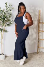 Side profile of Dark Navy Cyrella Muse Overalls, highlighting elegant wide-leg design.
