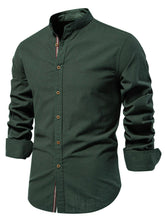 Front angle of men’s dark green Aura Lift Zenith mandarin collar button-up shirt with foldable sleeves.
