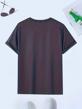 Back view of men’s dark grey Cosmic Voyager astronaut graphic tee styled on hanger with white sneakers