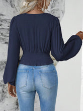Back view illustrating the dark blue Balloonique blouse's fit and design.