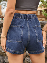 Back shot of deep dark blue high-waist denim shorts showing the pocket and belt loop arrangement.