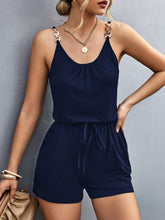 Model wearing Sunkiss Move Romper in dark blue, showcasing scoop neckline, adjustable buckle straps, and elastic drawstring waist.