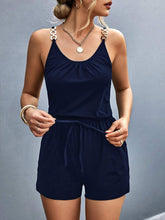 Model wearing dark blue romper at a marina dock, styled with white sneakers and a canvas tote—ideal for relaxed coastal outings or resort strolling.