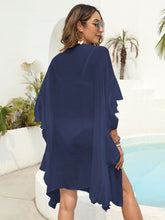 Back view of dark blue ruffled open-front beach cover-up showing relaxed fit and lightweight, flowing fabric