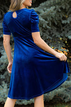 Back view of Seylurette Velvet Dress in dark blue featuring puff sleeves and delicate button neck closure.