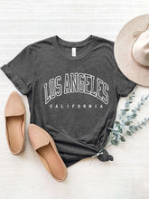 CaliVista Tee in dark gray paired with straw hat and tan loafers in flat lay, styled for casual summer outfit inspiration.