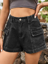 Woman in a cozy knit sweater and dark gray Joyful Journey Denim shorts reading a book in a coffee shop.