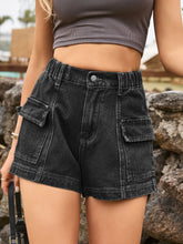 Woman in a black turtleneck and dark gray Joyful Journey Denim shorts looking out a window.