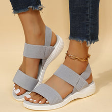 Model wearing Rubber Open Toe Low Heel Sandals in dark gray