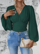 Model styled in dark green Balloonique™ Blouse with accessories for a complete look.