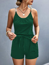 Model wearing Sunkiss Move Romper in dark green, showcasing scoop neckline, adjustable buckle straps, and elastic drawstring waist.