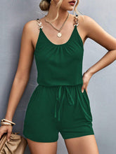 Model in dark green romper at a weekend market, styled with espadrilles and a crossbody bag—versatile enough for casual errands or slow Sunday style.