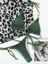 Front flat lay of dark green textured halter neck tie side bikini set with gold O-ring details and adjustable straps