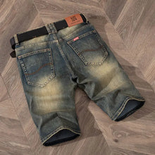 Men's dark medium vintage wash stretch denim bermuda shorts back view.