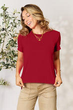Model wearing Full Size Round Neck Short Sleeve T-Shirt in soft deep red