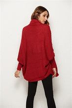 Back view of woman modeling Deep Red SeraphinaWing Cardigan with dramatic sleeve drape and hood detail.