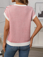 Back view of deep red striped knit top showing smooth fit and clean stripe alignment, worn with black trousers.