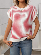 Side profile of model in deep red striped knit top, styled with white linen pants for an airy summer vibe.