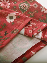 Close-up of deep red fabric and geometric floral design on Printed Notched Short Sleeve Blouse