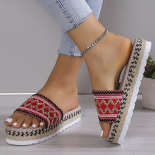 a model wearing a red pair of Geometric Weave Platform Sandals