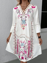 Woman at a sunset dinner party wearing Deep Rose Qelorian Lace Mini Dress paired with bronze jewelry and sandals.