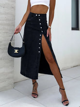 Denavelle Row Skirt front view in dark black denim with exposed seams and side button slit